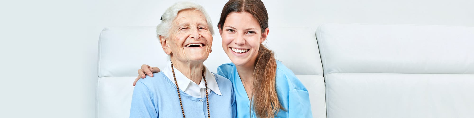 portrait  of caregiver and senior woman smiling
