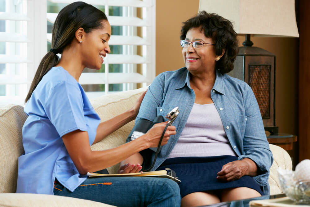 nurse giving blood pressure test on a senior woman